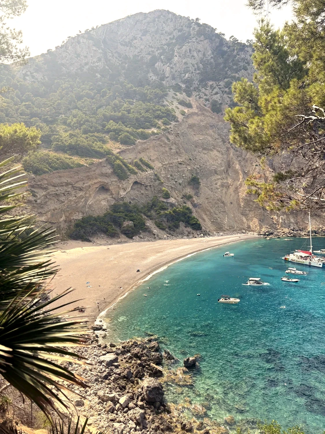 Sunlit turquoise bay and limestone shoreline, photographed on Mallorca